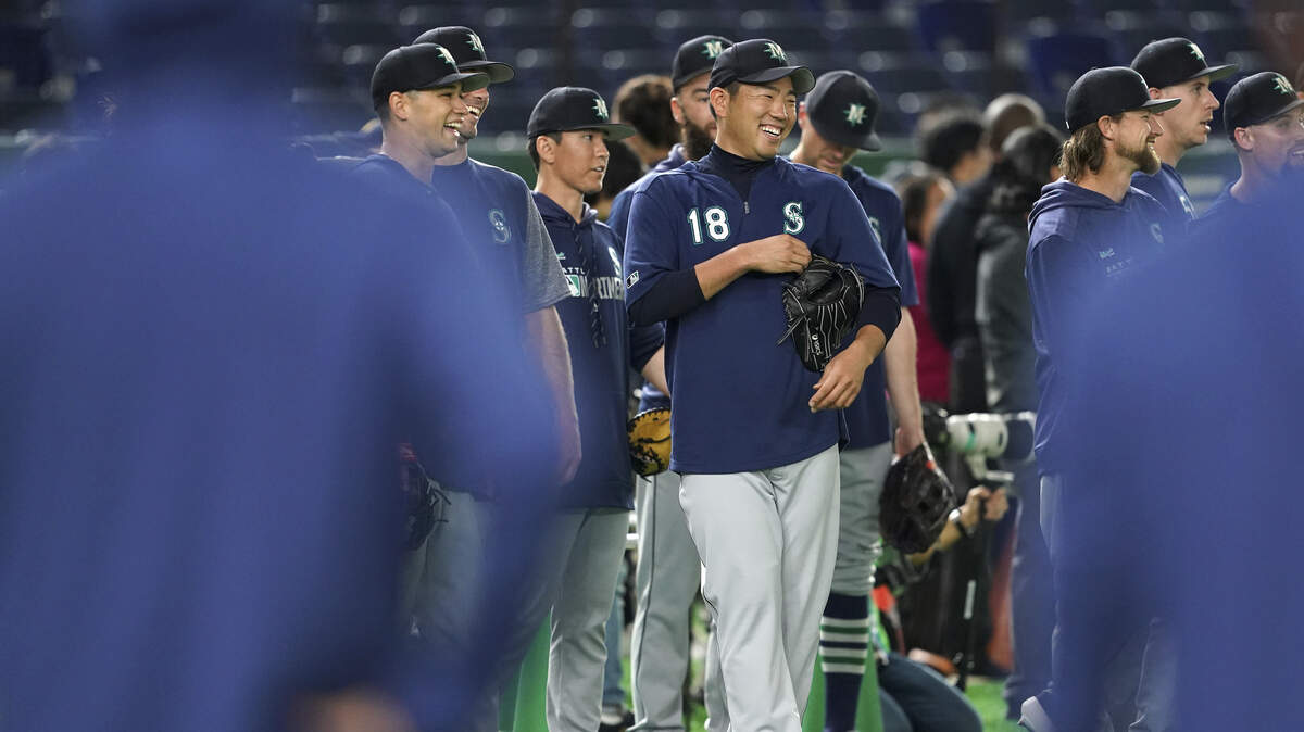 Seattle Mariners pitcher Yusei Kikuchi (18) laughs with teammates during his team’s practice at Tokyo Dome in Tokyo, Saturday, March 16, 2019. Just as he was adjusting to life in the United States, Kikuchi is back in Japan getting ready to make his Major League pitching debut in front of a sellout crowd at Tokyo Dome. Kikuchi will be on the mound in Game 2 of the MarinersÅf season-opening series in Japan. (AP Photo/Eugene Hoshiko)