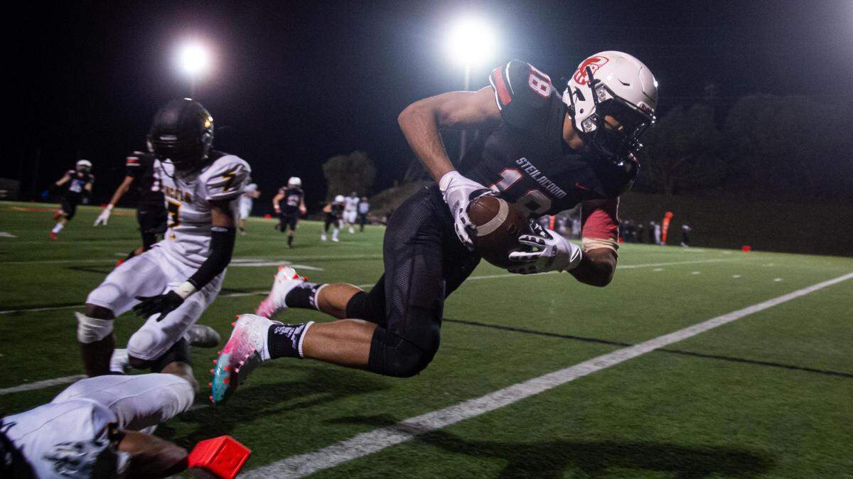 Steilacoom’s DJ Fryar leaps into the end zone for a touchdown during the fourth quarter. Lincoln played Steilacoom in a football game at Steilacoom High School in Steilacoom, Wash., on Friday, March 12, 2021.