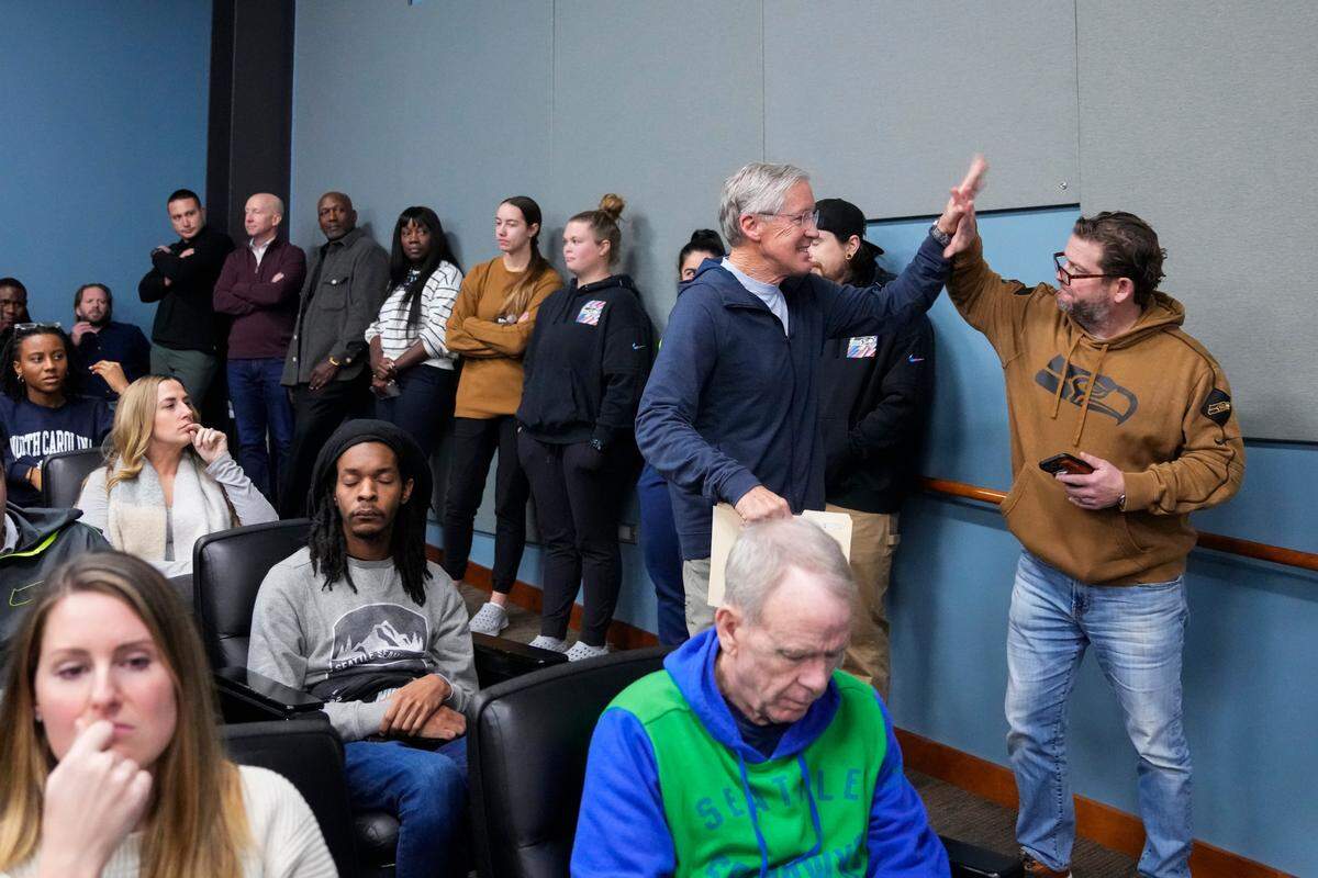Former Seattle Seahawks head coach Pete Carroll greets general manager John Schneider, right, during a media availability after it was announced Carroll will not return as head coach next season, Wednesday, Jan. 10, 2024, at the NFL football team’s headquarters in Renton, Wash. Carroll will remain with the organization as an advisor. (AP Photo/Lindsey Wasson)