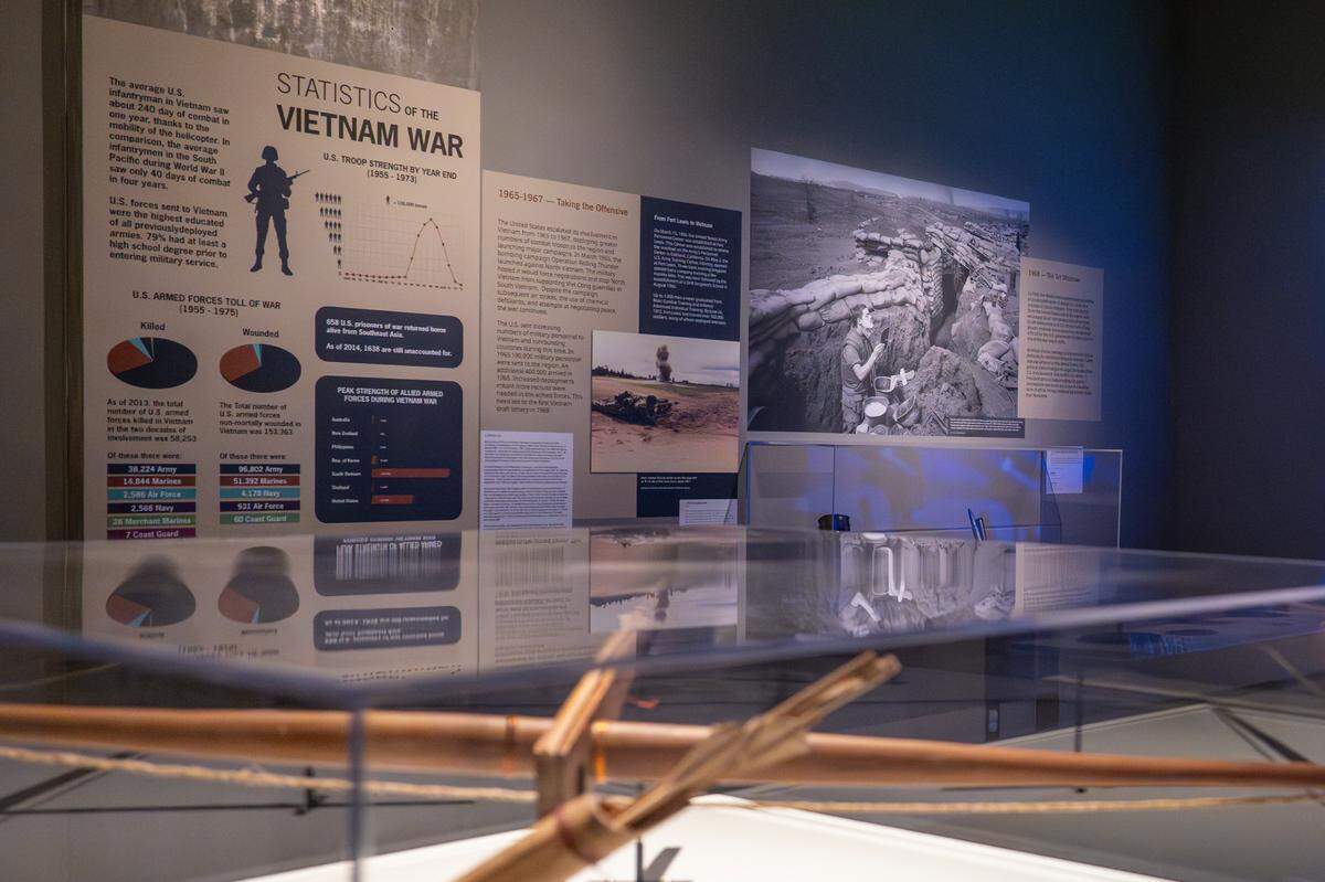 Information and photos from the Vietnam War line the wall of “The Things They Brought Home,” an exhibit at the Washington State History Museum on Thursday, April 24, 2025, in Tacoma. The exhibit showcases the stories of Washington’s Vietnam War veterans by displaying a collection of personal objects that people brought back from their service.
