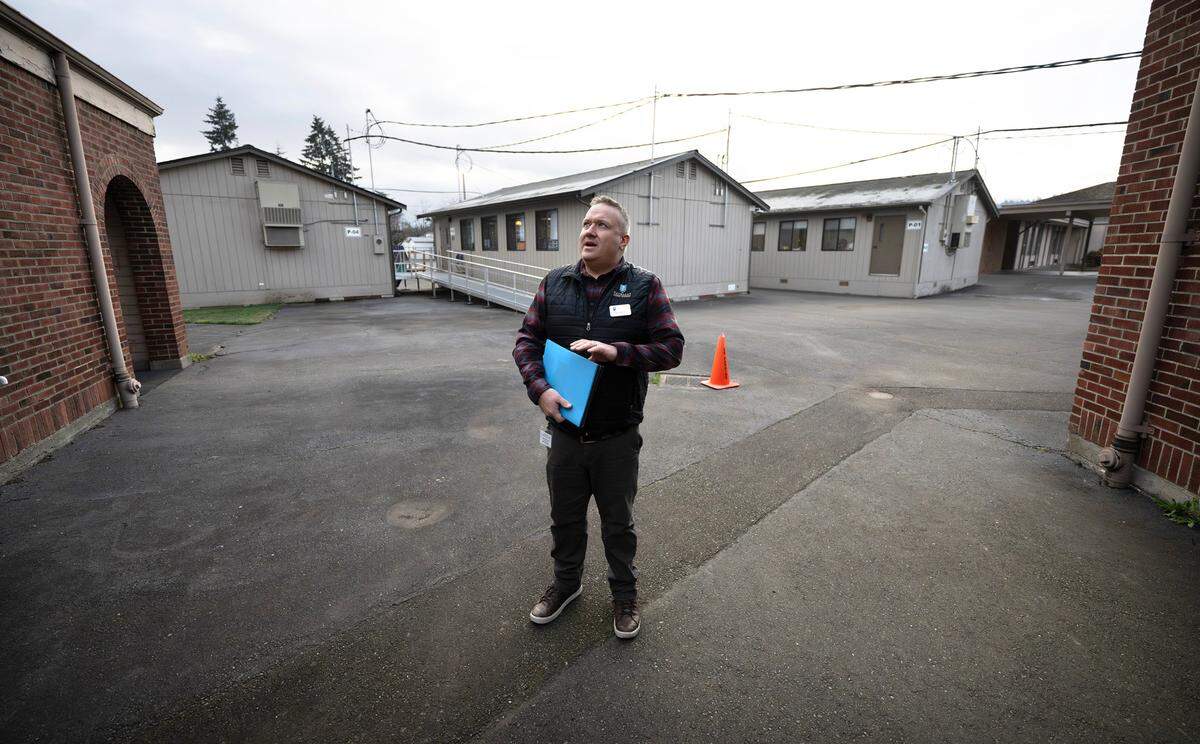 Capital projects director Brady Martin looks up at the aging roofs at Spinning Elementary School in Puyallup, Washington, on Thursday, Jan. 30, 2025. A proposed $800 million bond for the Puyallup School District would include construction of a new school building on the same property.