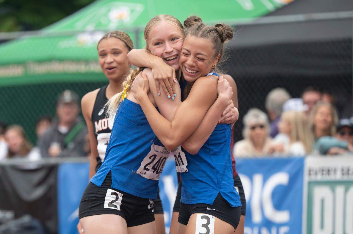 Tahoma’s Ava Foy and Sofia Guevara, right, embrace after the 4A girls 100-meter dash final on Saturday, May 31, 2025, during the 2025 WIAA Track & Field Championships at Mount Tahoma High School in Tacoma, Wash. Guevara placed second and Foy placed fourth in the race.