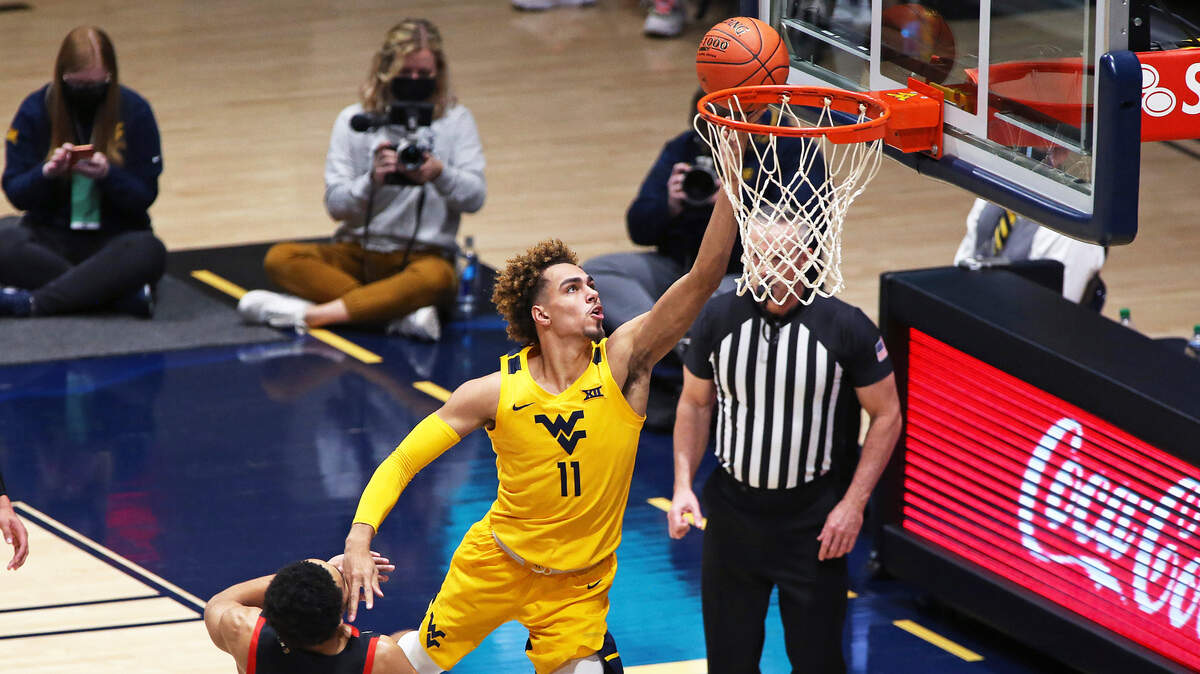 West Virginia forward Emmitt Matthews Jr. (11) shoots while defended by Texas Tech guard Micah Peavy (5) during the second half of an NCAA college basketball game Monday, Jan. 25, 2021, in Morgantown, W.Va. (AP Photo/Kathleen Batten)