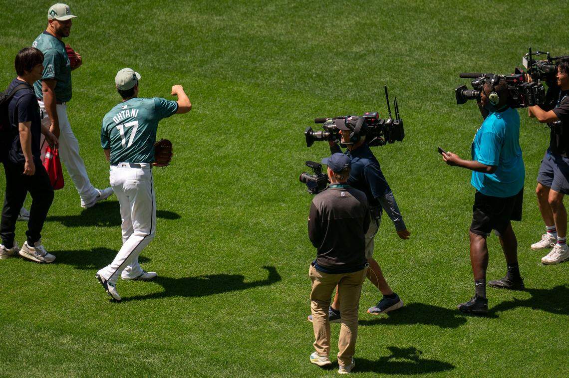 Camera crews surround Los Angeles Angels star Shohei Ohtani as he walks toward the outfield to warm up prior to the start of the 2023 MLB All-Star Game on Tuesday, July 11, 2023, at T-Mobile Park in Seattle.