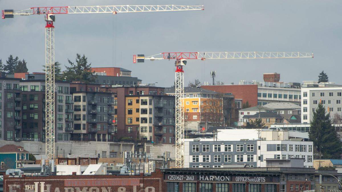 A pair of cranes stand above an apartment building just beginning construction on the Tacoma skyline earlier this year. A proposed new apartment project was announced Nov. 16 by Harbor Custom Development.