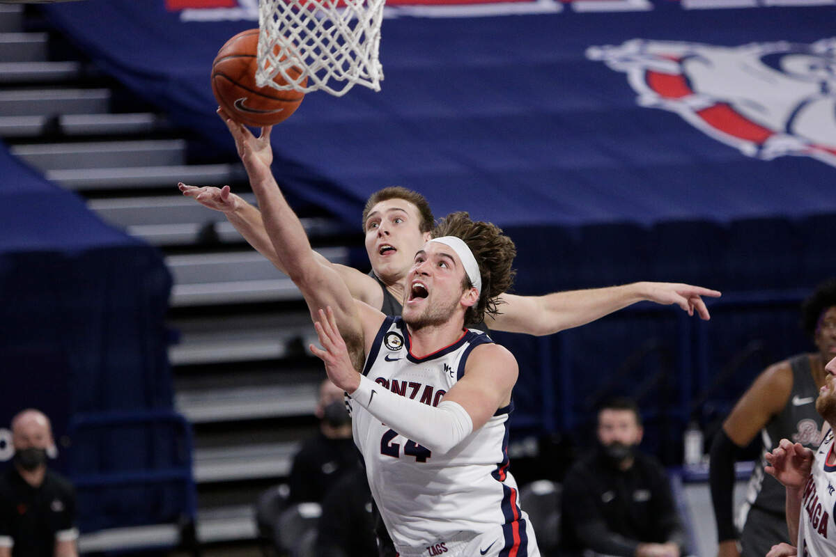 Gonzaga forward Corey Kispert, front, shoots in front of Santa Clara forward Josip Vrankic during the second half of an NCAA college basketball game in Spokane, Wash., Thursday, Feb. 25, 2021. (AP Photo/Young Kwak)