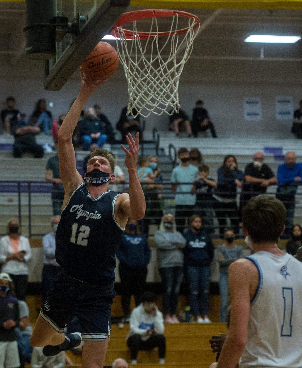 Olympia High School forward Jackson Grant puts up a shot during the 4A SPSL boys basketball championship game against Curtis on Thursday, June 10, 2021 at Puyallup High School in Puyallup, Wash.