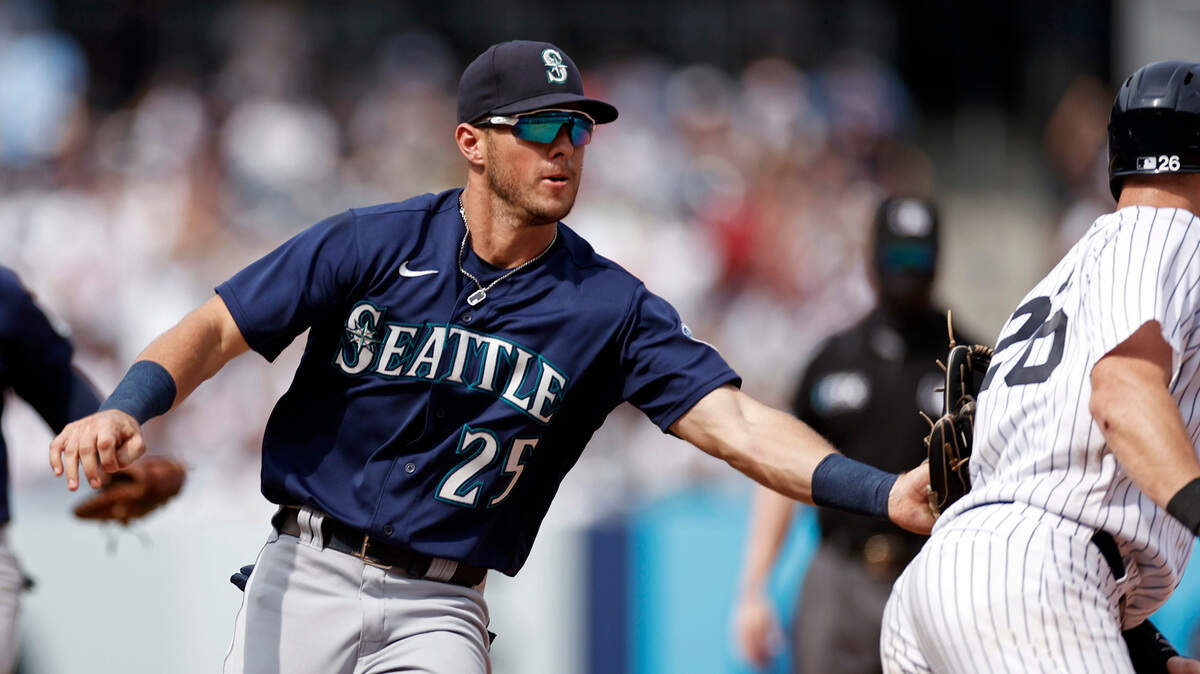 Seattle Mariners shortstop Dylan Moore (25) tags out New York Yankees’ DJ LeMahieu during the sixth inning of a baseball game on Saturday, Aug. 7, 2021, in New York. (AP Photo/Adam Hunger)