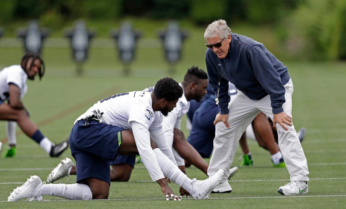 Veteran cornerback Byron Maxwell talks with coach Pete Carroll before a Seahawks practice. Maxwell, 30, is battling rookie Tre Flowers and former San Francisco 49ers starter Dontae Johnson to be Seattle’s right cornerback.
