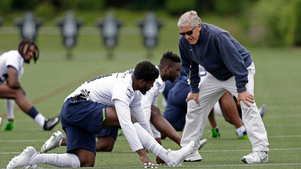 Veteran cornerback Byron Maxwell talks with coach Pete Carroll before a Seahawks practice. Maxwell, 30, is battling rookie Tre Flowers and former San Francisco 49ers starter Dontae Johnson to be Seattle’s right cornerback.
