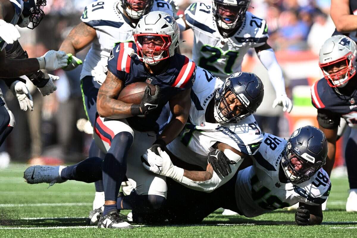 Sep 15, 2024; Foxborough, Massachusetts, USA; Seattle Seahawks defensive tackle Johnathan Hankins (97) tackles New England Patriots running back Antonio Gibson (4) during the second half at Gillette Stadium. Mandatory Credit: Brian Fluharty-Imagn Images
