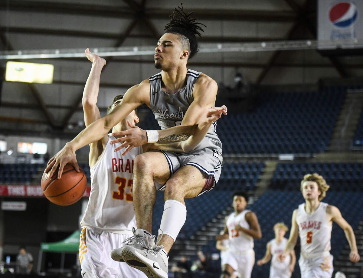 Wilson’s Damani Green goes airborne to keep the ball in play during the third quarter. Wilson played Kamiakin in a basketball game at Hardwood Classic at the Tacoma Dome in Tacoma, Wash., on Saturday, March 7, 2020.