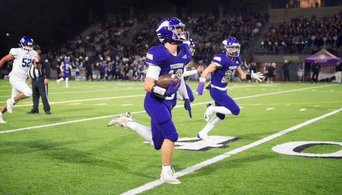 Puyallup defensive back Jacek Garden returns an interception for a touchdown during Friday night’s football game against the Curtis Vikings at Sparks Stadium in Puyallup, Washington, Oct. 25, 2024. Puyallup won the game, 49-35.