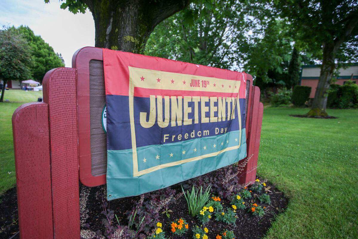 A group of community members in Puyallup celebrated Juneteenth on Saturday, June 10, 2023 at Grayland Park. Some vendors at the event sold lemonade, cakes, cookies and vegan food. Music played in the background as people danced and spoke with each other. There was a bouncy house.
