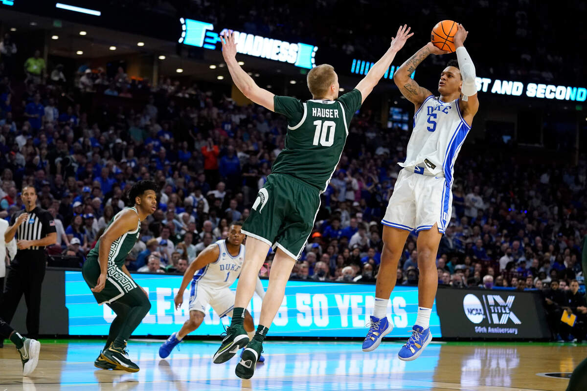 Duke forward Paolo Banchero shoots over Michigan State forward Joey Hauser during the first half of a college basketball game in the second round of the NCAA tournament on Sunday, March 20, 2022, in Greenville, S.C. (AP Photo/Chris Carlson)