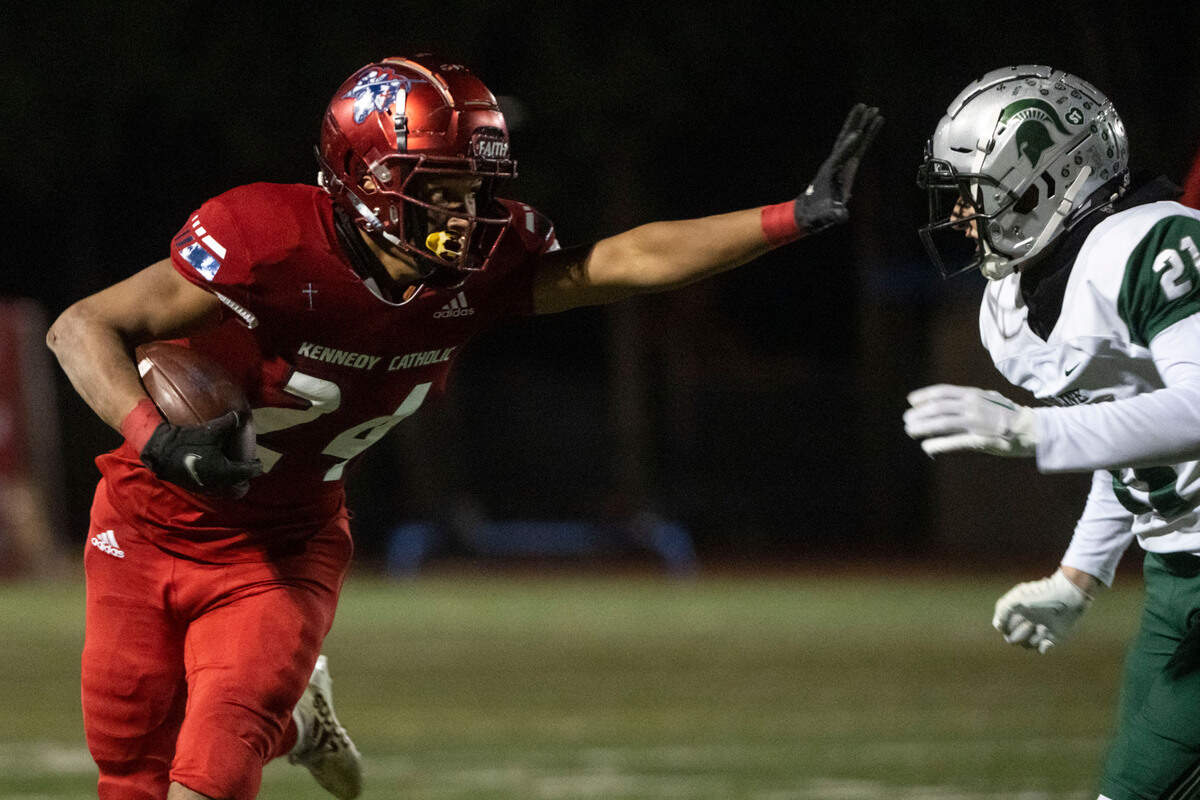 Kennedy Catholic running back Xe’Ree Alexander prepares to stiff arm Skyline Michael Roni on his way to the endzone for a rushing touchdown in the second quarter of a Class 4A state quarterfinal game on Friday, Nov. 18, 2022, at Highline Memorial Stadium in Burien, Wash.