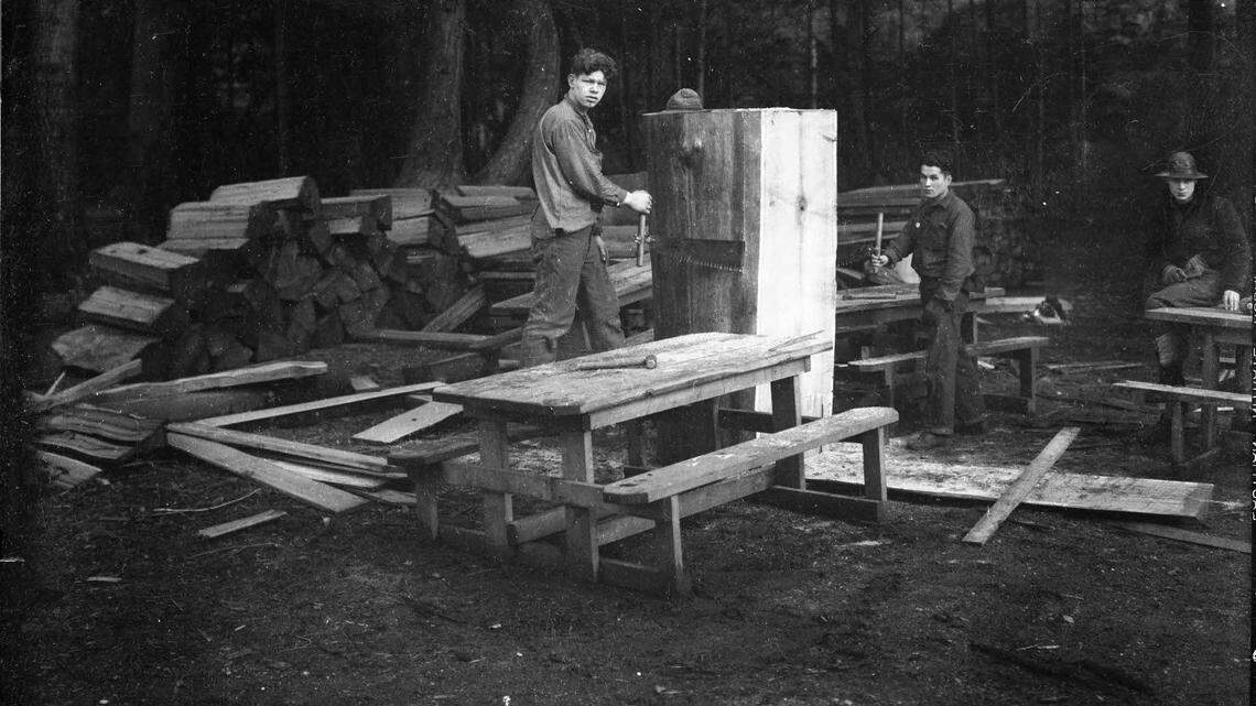 Civilian Conservation Corps members build picnic tables at a Washington state park.