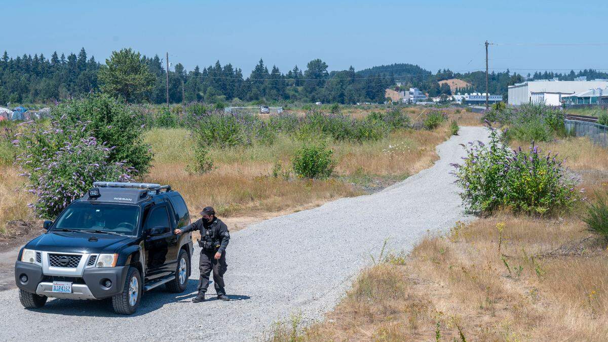 A security detail checks out the fence area at the proposed Bridge Industrial site July 27, 2022, in Tacoma. Bridge Industrial plans to redevelop about 150 acres of the former BNSF site in South Tacoma.