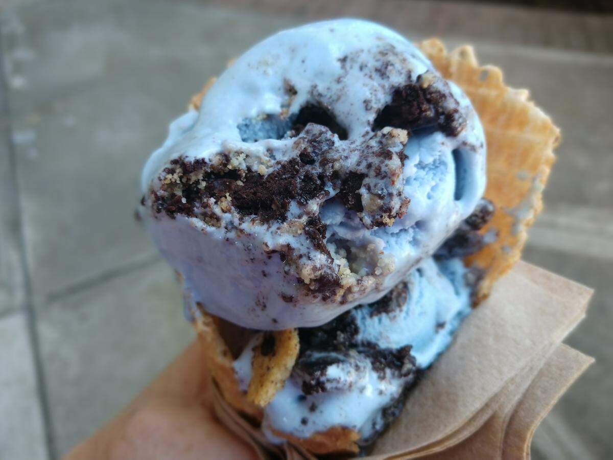 Cookie monster ice cream in a waffle cone from Bliss Small Batch Creamery.