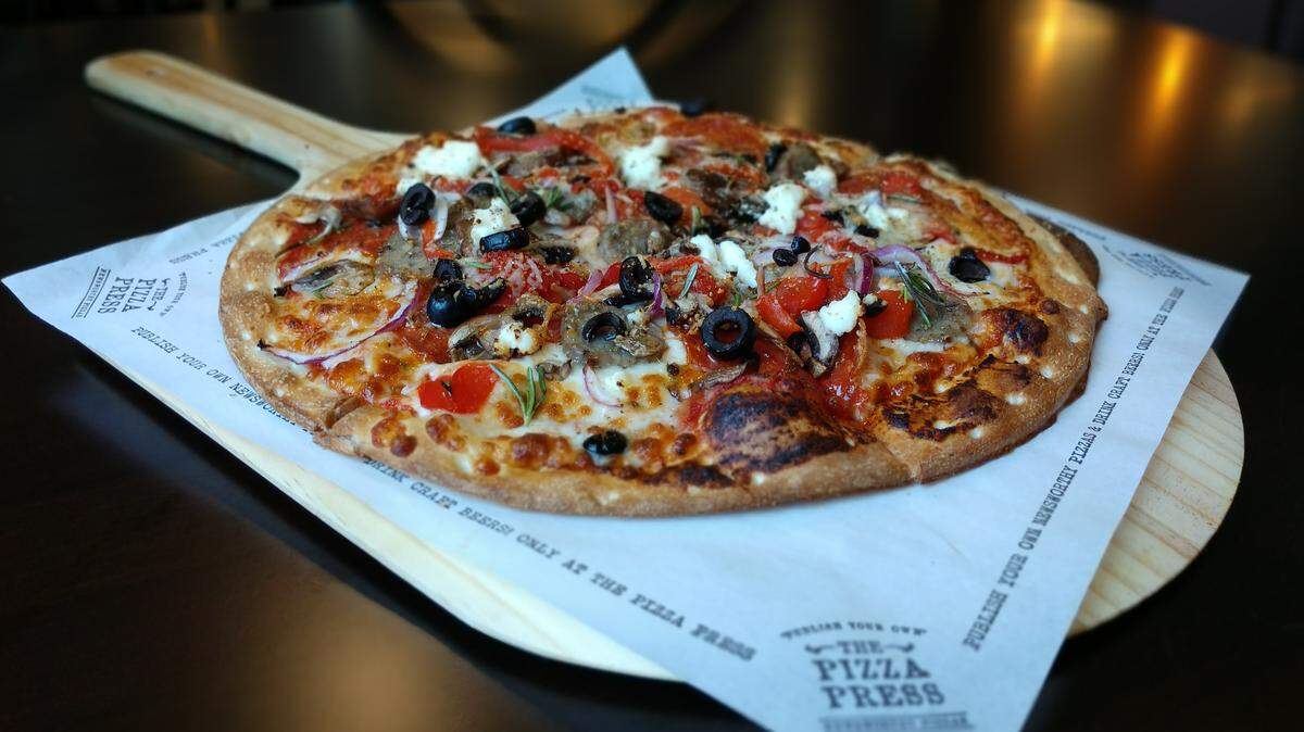 The Tribune pizza, a blend of pepperoni and sausage with red onion, mushroom, roasted red bell pepper, kalamata olives and ricotta cheese, from the The Pizza Press.