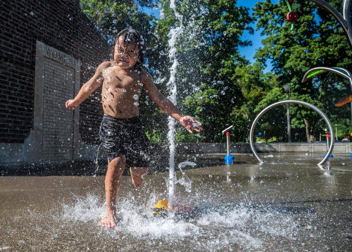 Vinny Ballesteros, 4, plays in the water with his toy truck at the spray ground in Wright Park in Tacoma on Monday, June 20, 2022.