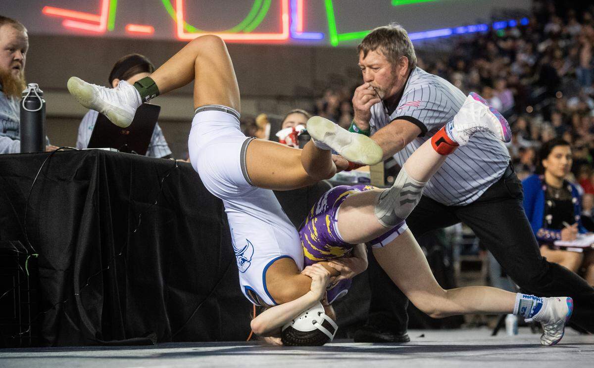 Federal Way’s Kayla McKinley-Johnson and Hanford’s Taylor Wilson grapple during the girls 100 lb championship on day two of Mat Classic XXXII at the Tacoma Dome in Tacoma, Wash., on Saturday, Feb. 22, 2020.