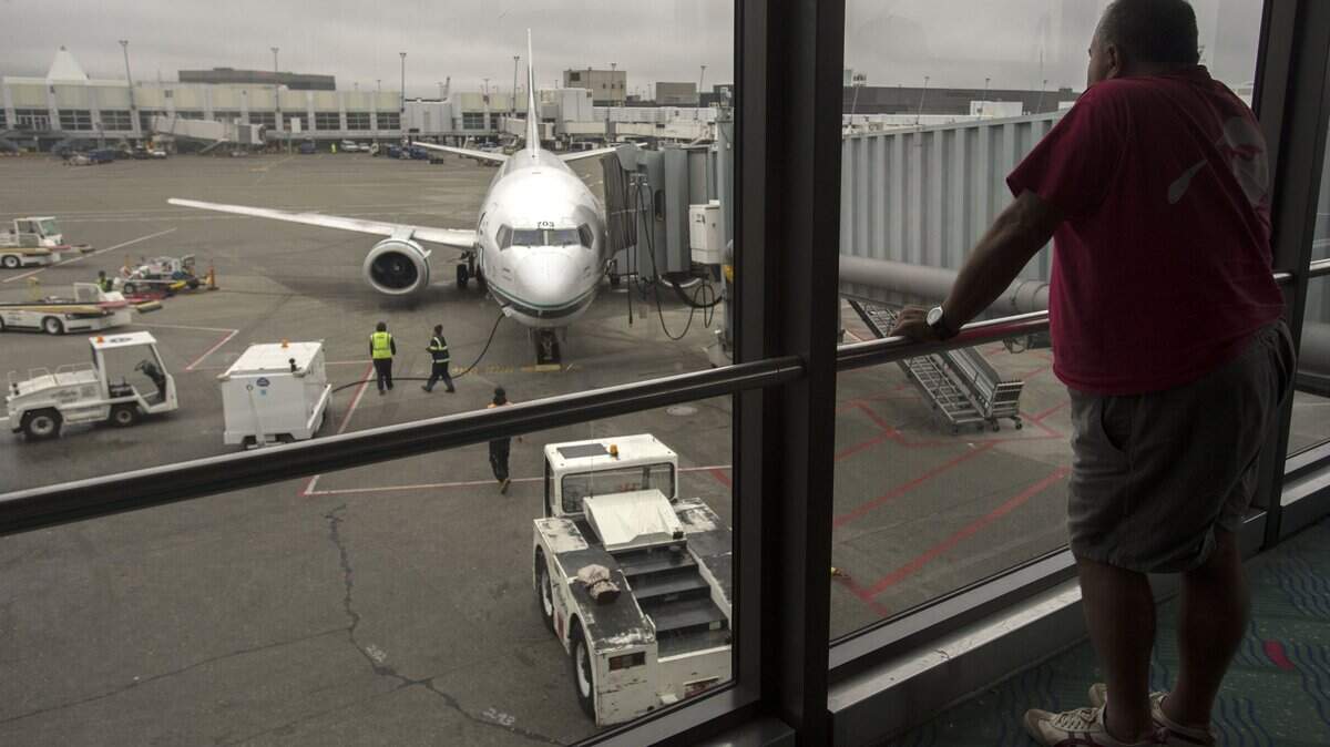 An Alaska Airlines passenger waits to board his flight at the north terminal at Sea-Tac Airport in 2015.