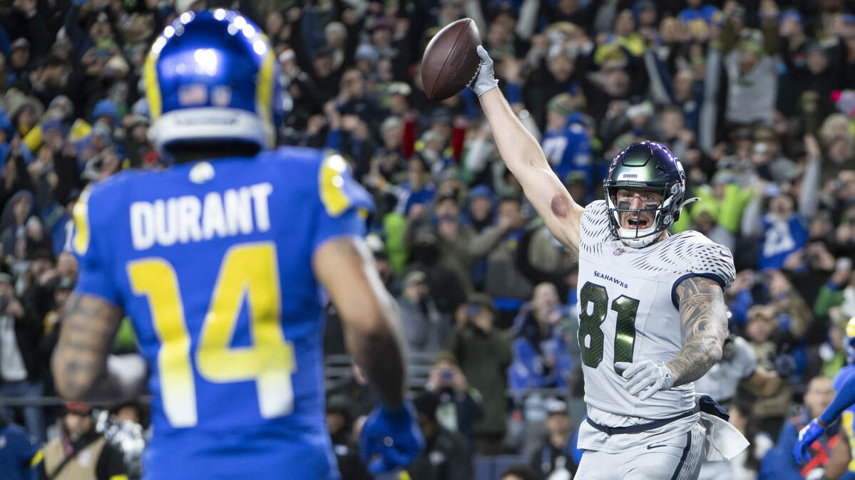 Seattle Seahawks tight end Eric Saubert (81) raises the ball in celebration of his two point conversion, winning the game against the Los Angeles Rams in overtime at Lumen Field, on Thursday, Dec. 18, 2025, in Seattle.