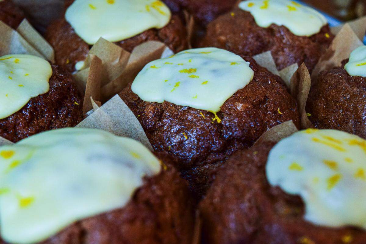 The carrot muffins topped with lemon-zested frosting are one of about 50 items on the shelf.