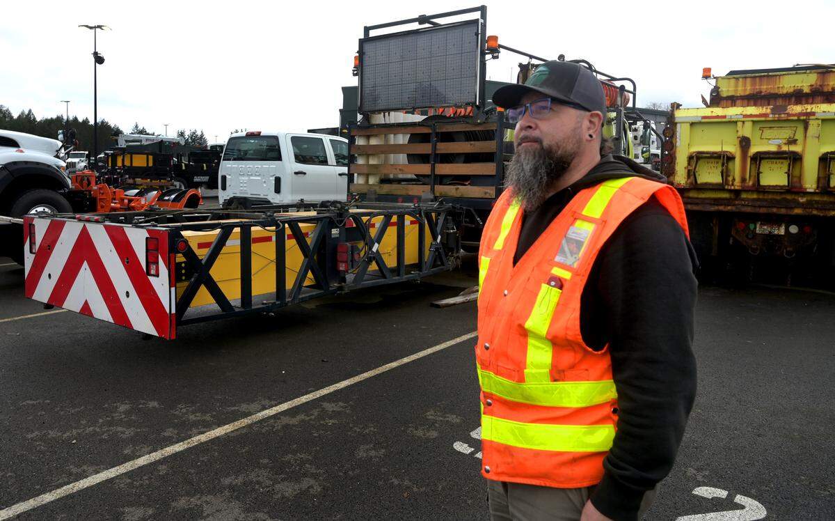 Standing near a truck mounted attenuator system WSDOT highway maintenance worker Adam Gonzales talks about his job one March 19, 2024, at the Olympic Region Maintenance and Operations Facility in Lacey.