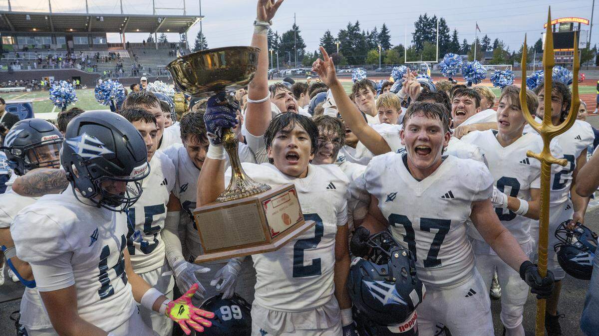 Gig Harbor celebrates their win over Peninsula after receiving the Fish Bowl trophy on Saturday, Sept. 6, 2025, at Mount Tahoma Stadium in Tacoma, Wash.