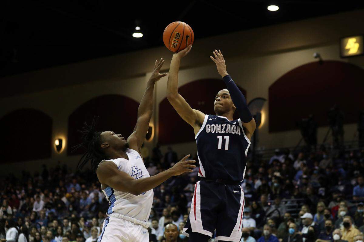 Gonzaga guard Nolan Hickman (11) takes a jump shot over San Diego guard Wayne McKinney III (3) in the first half of an NCAA college basketball game Thursday, Feb. 3, 2022, in San Diego. (AP Photo/Derrick Tuskan)