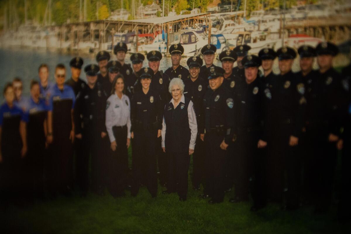 A photograph hanging on the wall of the Gig Harbor police station shows Marline McClane with the department’s officers.