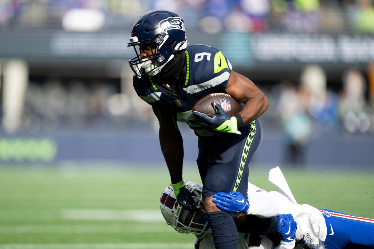 Seattle Seahawks running back Kenneth Walker III (9) carries the ball against Buffalo Bills cornerback Taron Johnson (7) during the first quarter of the game at Lumen Field, on Sunday, Oct. 27, 2024 in Seattle, Wash.