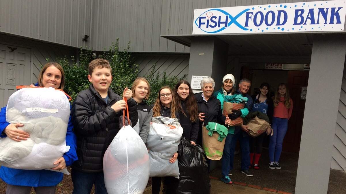 Sixth-graders from Harbor Ridge Middle School formed a line to pass bags of coats and blankets to the Gig Harbor Peninsula FISH food bank.