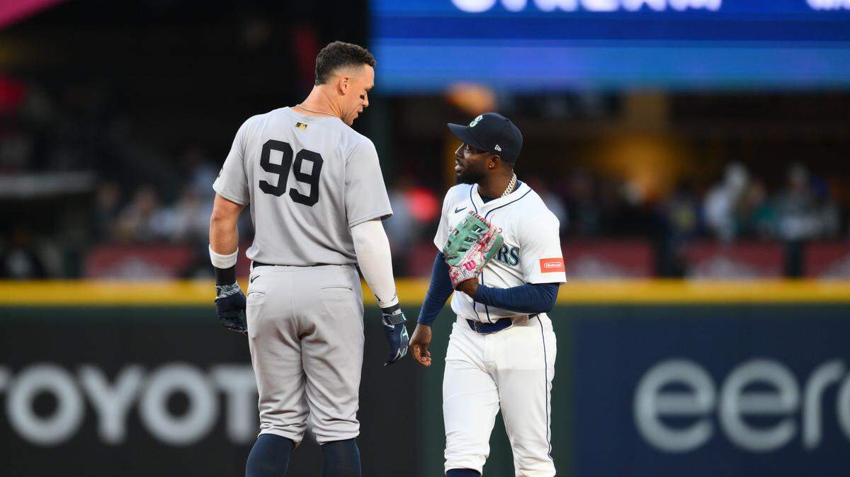 May 12, 2025; Seattle, Washington, USA; New York Yankees right fielder Aaron Judge (99) and Seattle Mariners left fielder Randy Arozarena (56) talk during the sixth inning at T-Mobile Park. Mandatory Credit: Steven Bisig-Imagn Images