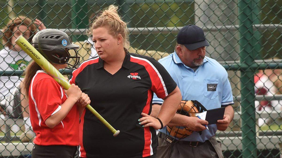 Yelm coach Lindsay Walton talks strategy with batter Cydney Jarvis as they battle Peninsula in the 3A West Central/Southwest bi-district softball tournament Saturday at the Regional Athletic Complex in Lacey.