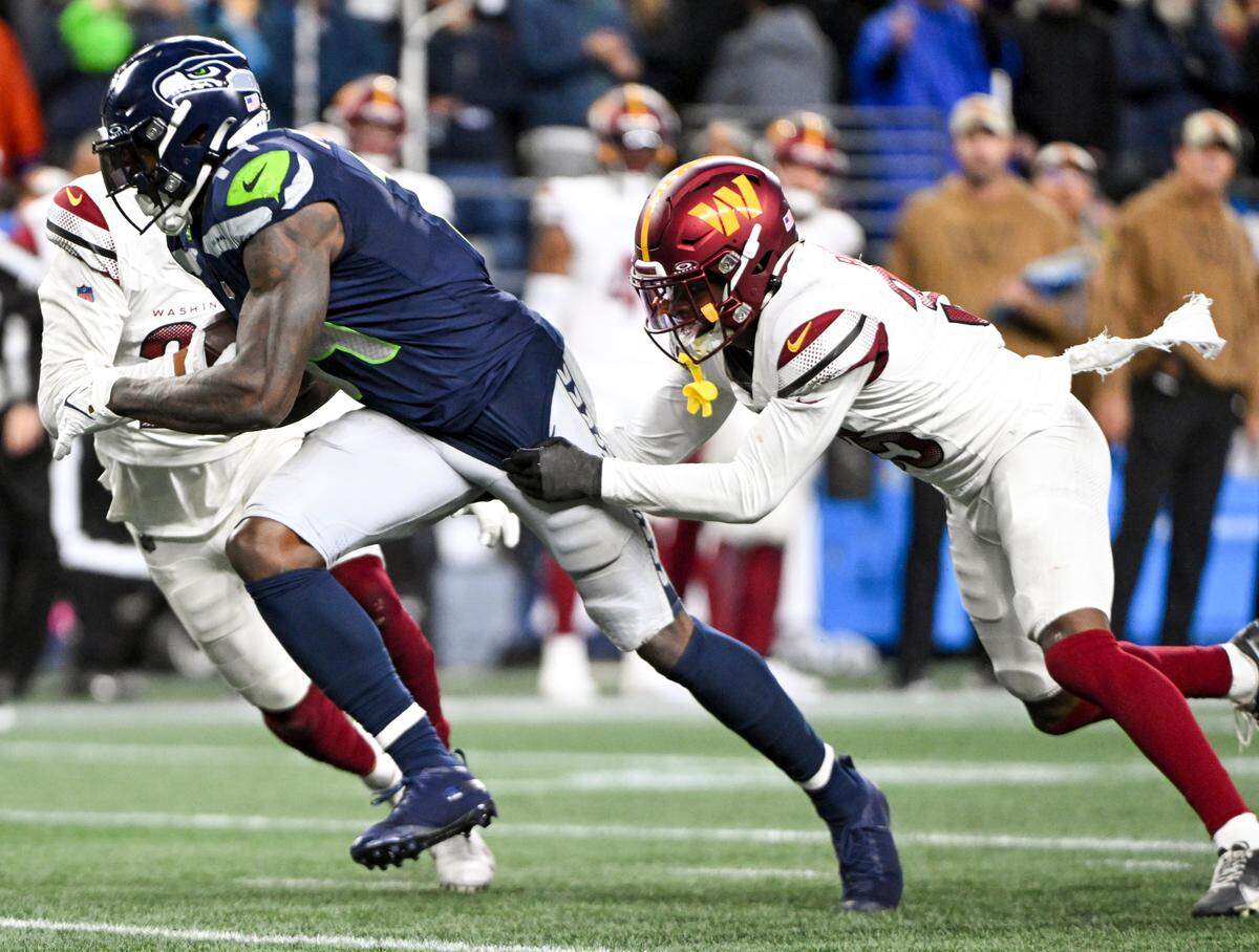 Seattle Seahawks wide receiver DK Metcalf (14) breaks away for a big gain against Washington Commanders safety Percy Butler (35) during the fourth quarter of the game at Lumen Field, on Sunday, Nov. 12, 2023, in Seattle, Wash.