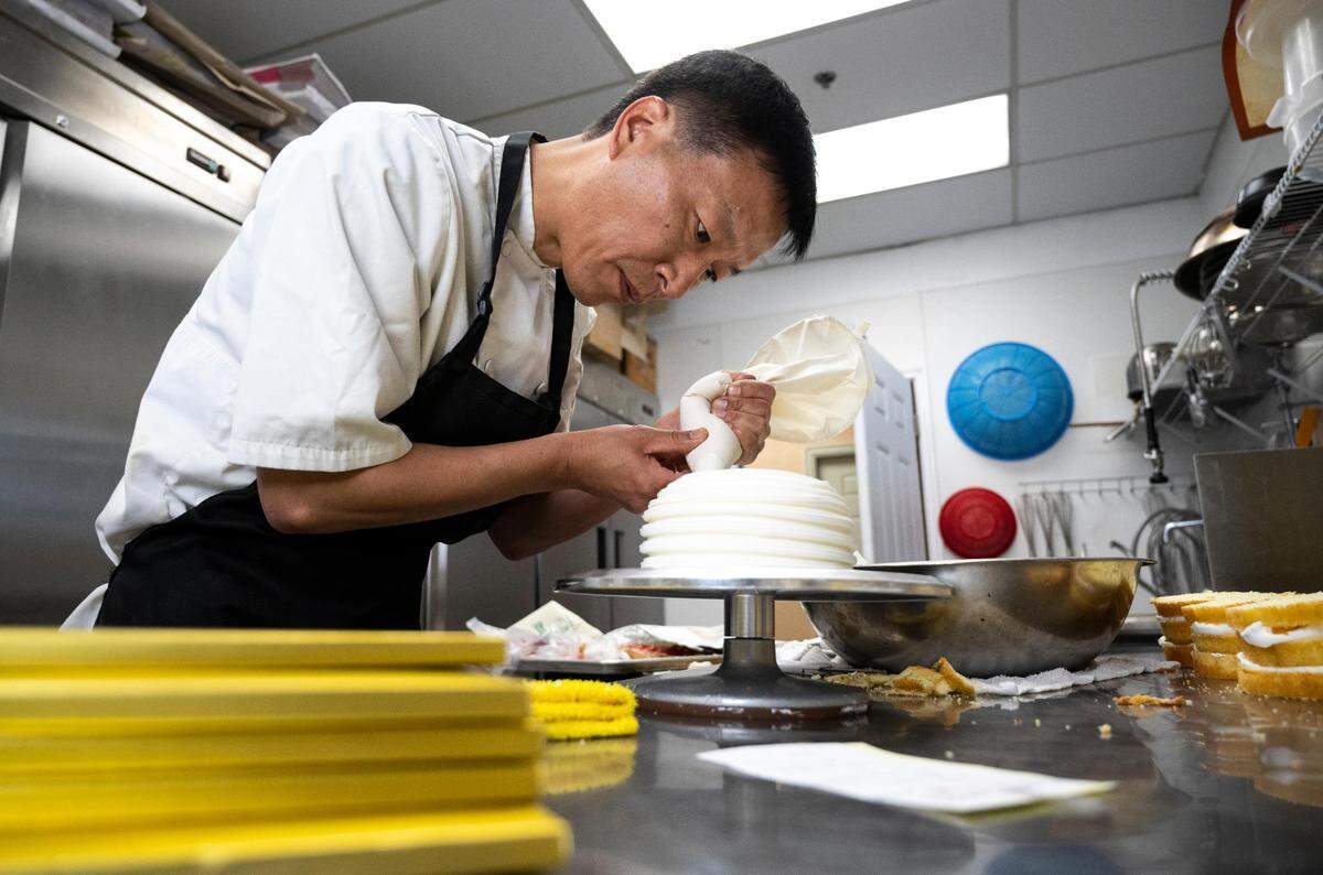 Chef Chris Chung, owner of Bon Bon Bakery, designs a cake with steadfast focus on the morning of Thursday, May 26, 2022.