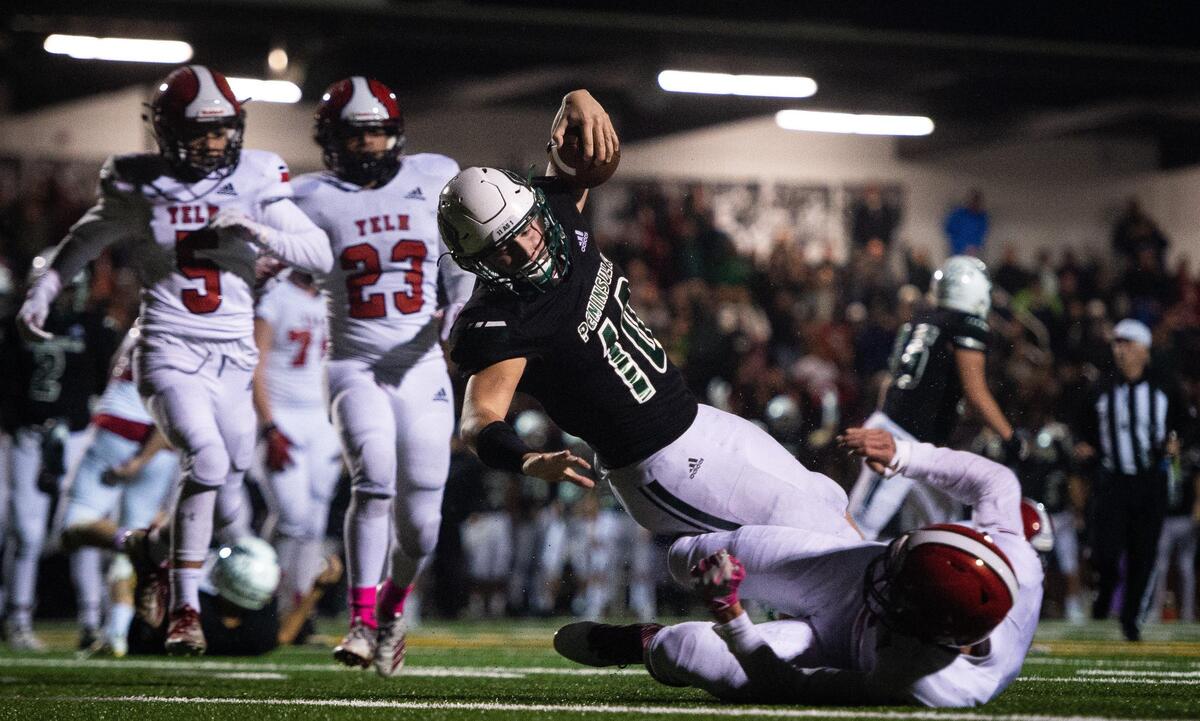 Peninsula’s Sean Skladany reaches for the end zone for a touchdown during a run in the second quarter. Peninsula played Yelm in a football game at Roy Anderson Field in Purdy, Wash., on Friday, Oct. 18, 2019.