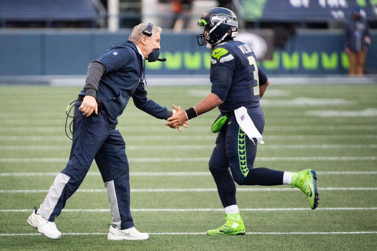 Head Coach Pete Carroll and Seattle Seahawks quarterback Russell Wilson celebrate after WilsonÕs touchdown during the third quarter. The Seattle Seahawks played the Los Angeles Rams in a NFL football game at Lumen Field in Seattle, Wash., on Sunday, Dec. 27, 2020.