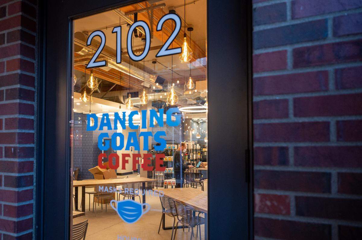 Aaron Shively, the director of operations for Dancing Goats Coffee, helps prepare the new downtown Tacoma coffee house for its opening day on Friday, Jan. 21, 2022. The coffee house, located at 2102 Commerce St., will open on Saturday, Jan. 22.
