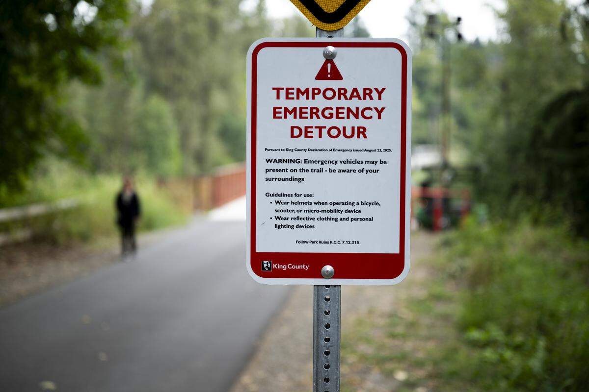 People walk and ride across the Foothills Trail Bridge as the White River Bridge remains closed on Wednesday, Aug. 27, 2025, in Buckley, Wash. The Foothills Bridge over the White River is the only thing connecting the towns of Buckley and Enumclaw.
