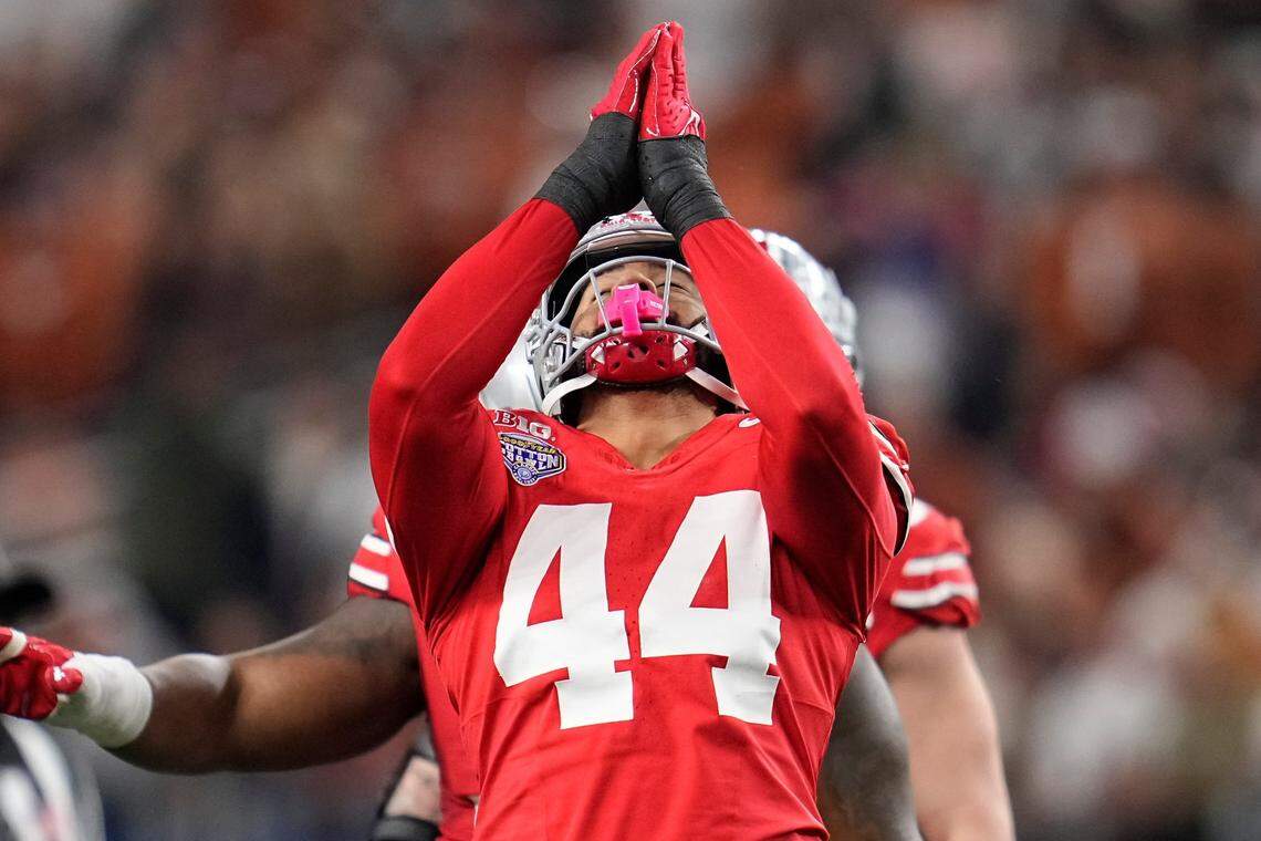 Ohio State Buckeyes defensive end JT Tuimoloau (44) celebrates a sack of Texas Longhorns quarterback Quinn Ewers (3) during the first half of the Cotton Bowl Classic College Football Playoff semifinal game at AT&T Stadium in Arlington, Texas on Jan. 10, 2025.