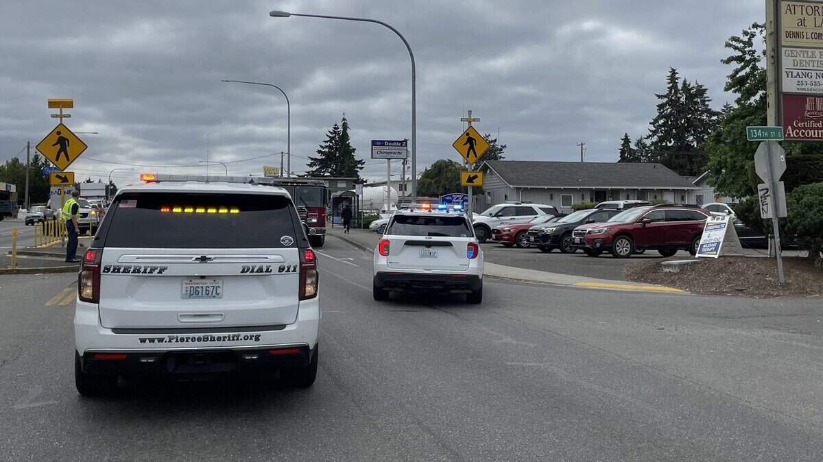 A vehicle struck a woman as she was walking across a crosswalk in Parkland on Tuesday.