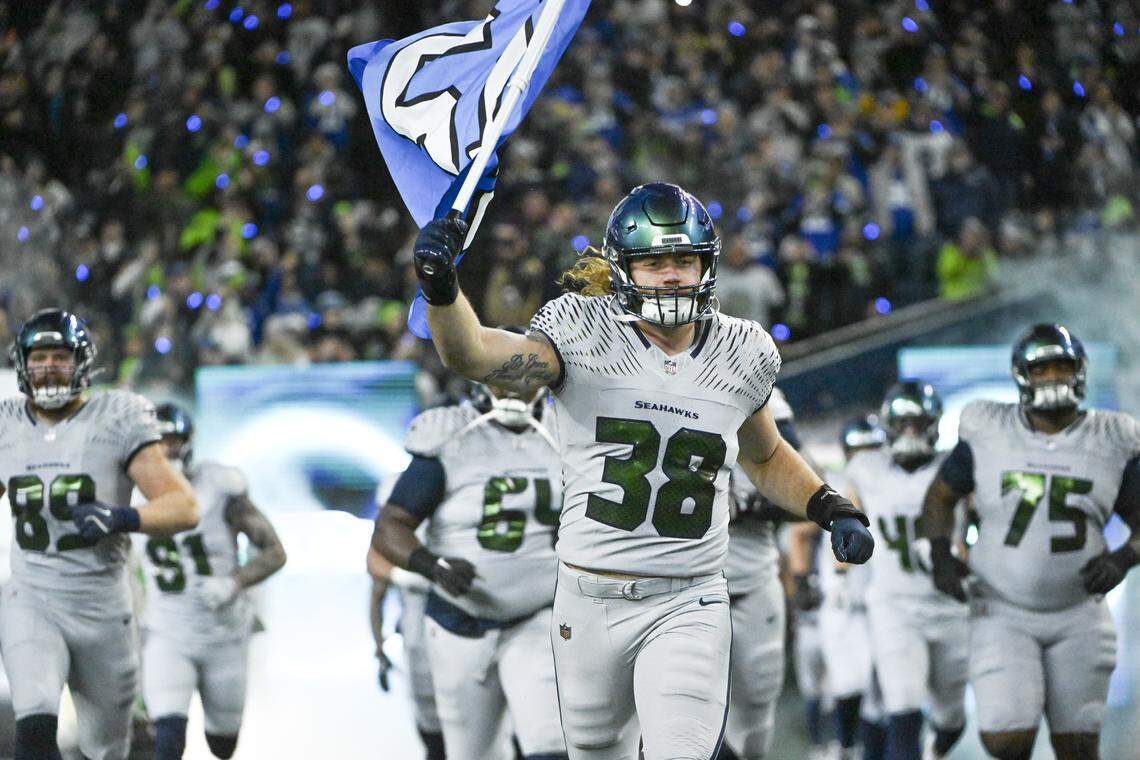 The Seattle Seahawks enter the field, led by fullback Brady Russell (38) before playing the Los Angeles Rams at Lumen Field, on Thursday, Dec. 18, 2025, in Seattle.