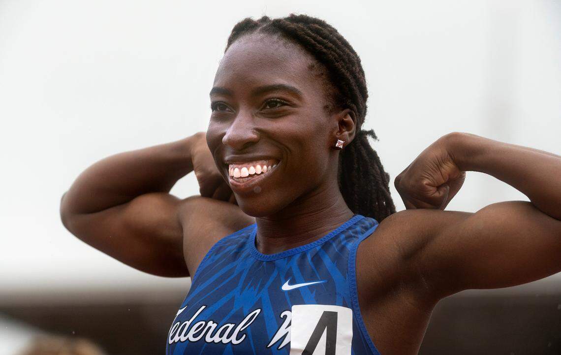 Federal Way’s Esther Akinlosotu flexes after running away with the 4A girls 100-meter dash state championship during the final day of the WIAA State Track and Field Championships at Mount Tahoma High School in Tacoma, Washington on Saturday, May 28, 2022.