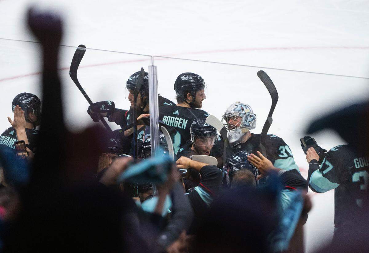 Seattle Kraken players celebrate after winning a first round 2023 Stanley Cup Playoffs game against the Colorado Avalanches in overtime at Climate Pledge Arena in Seattle on Monday, April 24, 2023. The Kraken won 3-2. The Kraken won 3-2.