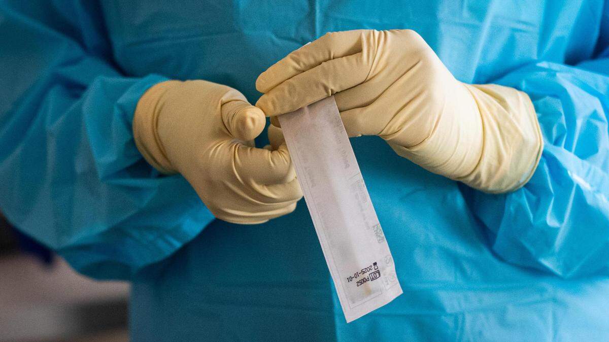 Mariam Sijad, a testing technician, holds a recently-used testing swab at GenCare Lifestyle at Point Ruston in Tacoma, Washington, on Friday, Jan. 22, 2021. San Luis Obispo County