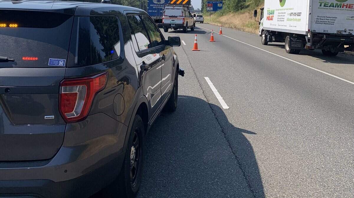 Washington State Patrol troopers redirect traffic around a stalled pickup truck on state Route 512. The vehicle was cleared around 2 p.m. Friday afternoon.